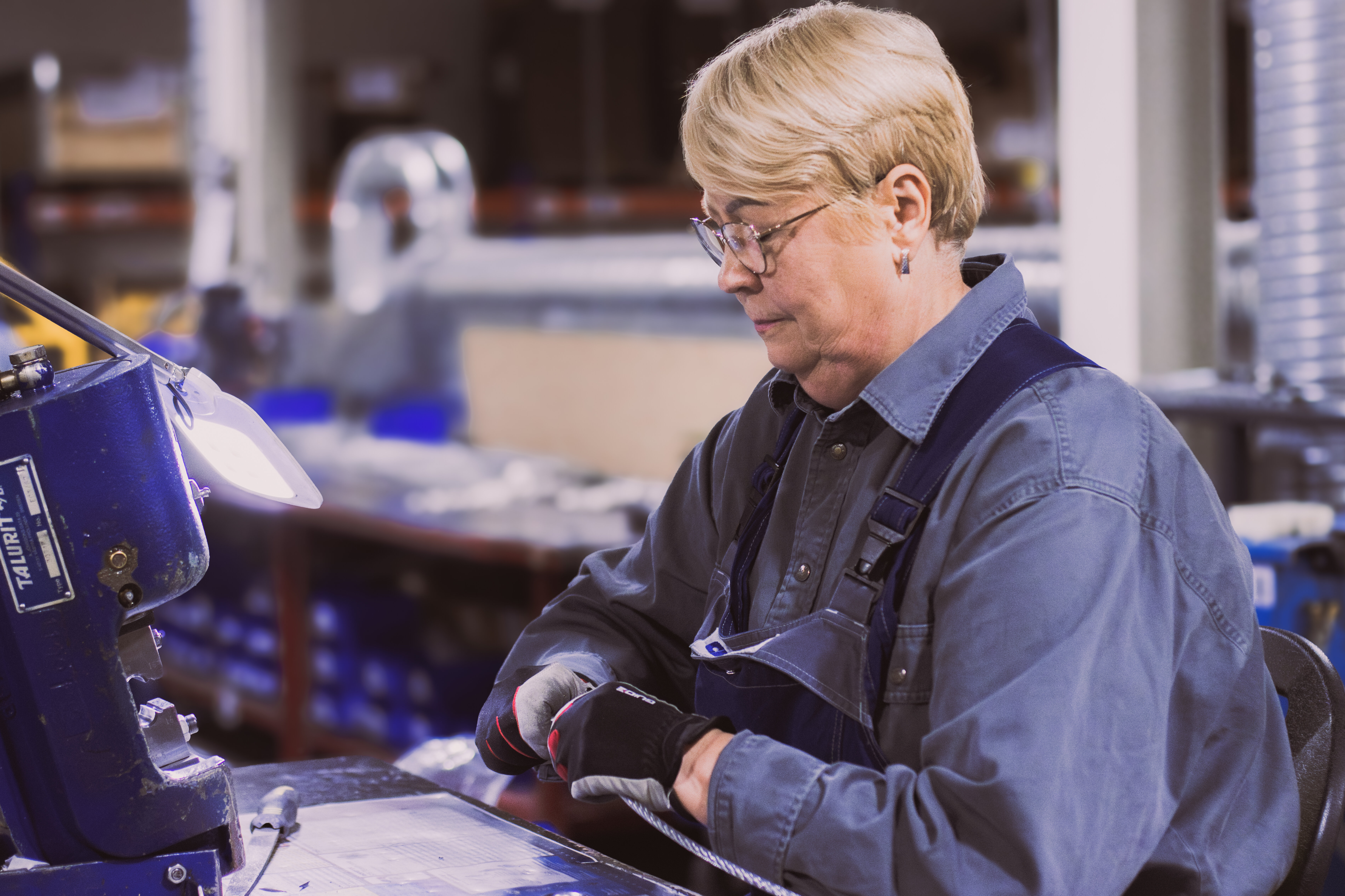 Employee inspects steel wire rope